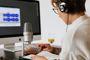 Person podcasting at home - build a home podcast studio setup